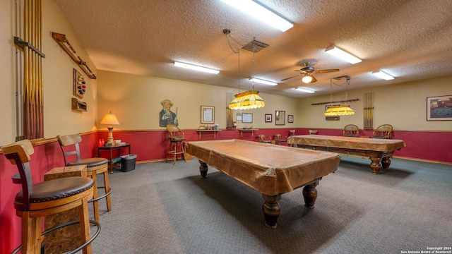 rec room with a textured ceiling, carpet floors, and billiards