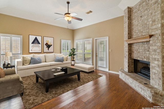 living room with ceiling fan, a fireplace, dark wood-type flooring, and vaulted ceiling