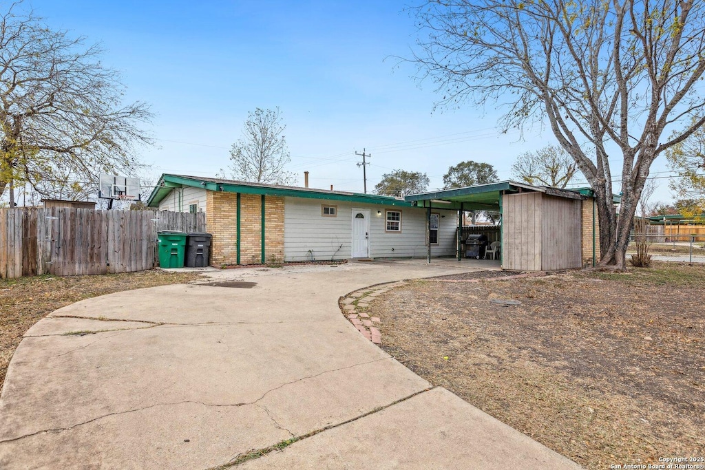 rear view of house featuring a carport