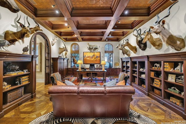 living area with baseboards, arched walkways, coffered ceiling, ornamental molding, and beam ceiling