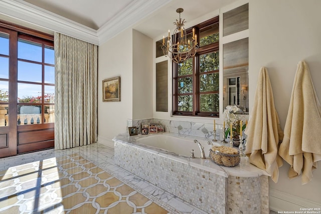 bathroom with a garden tub, a notable chandelier, baseboards, and crown molding