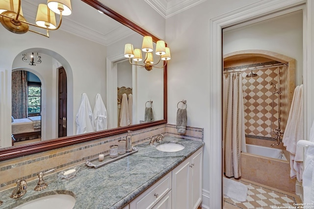 bathroom featuring crown molding, a sink, tiled shower / bath combo, and double vanity