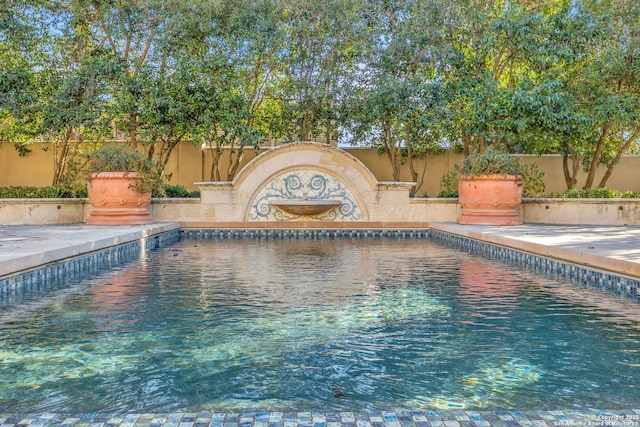 view of swimming pool featuring a fenced backyard