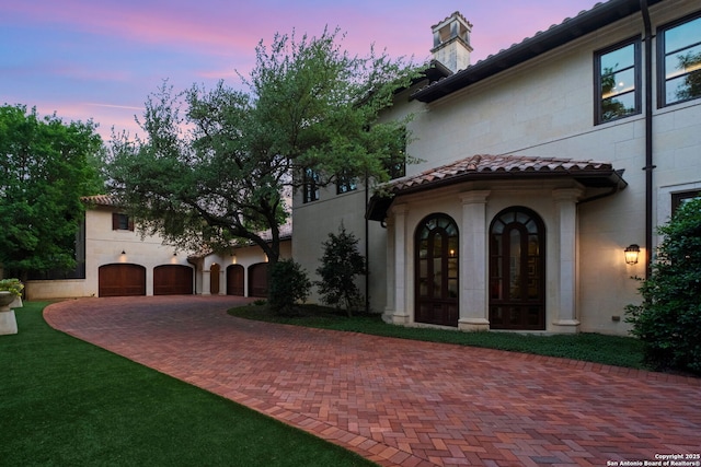 200 Geneseo Rd, Terrell Hills, TX 78209 - mediterranean / spanish house with curved driveway, a garage, and stucco siding