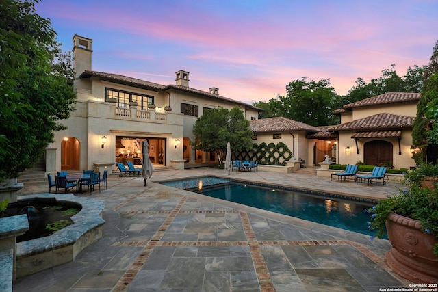 200 Geneseo Rd, Terrell Hills, TX 78209 - rear view of property featuring a balcony, a patio area, an outdoor pool, and a chimney