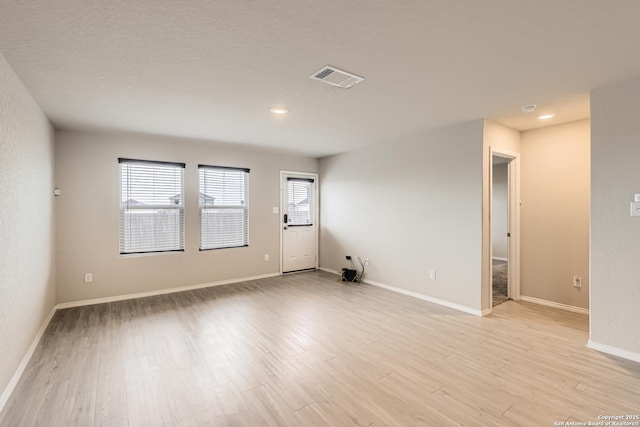 unfurnished room with light hardwood / wood-style flooring