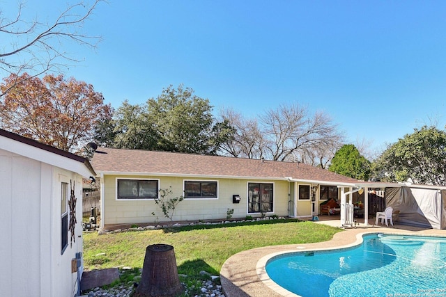 rear view of property with a patio area and a yard