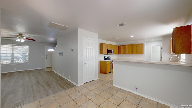 kitchen featuring ceiling fan, plenty of natural light, sink, and appliances with stainless steel finishes