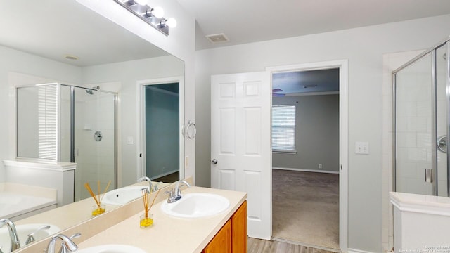 bathroom featuring a shower with door, vanity, and hardwood / wood-style flooring