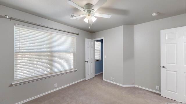 carpeted empty room with ceiling fan