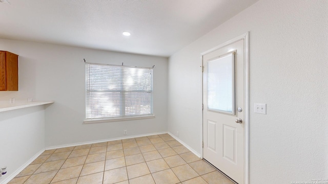 unfurnished dining area featuring light tile patterned floors and a wealth of natural light