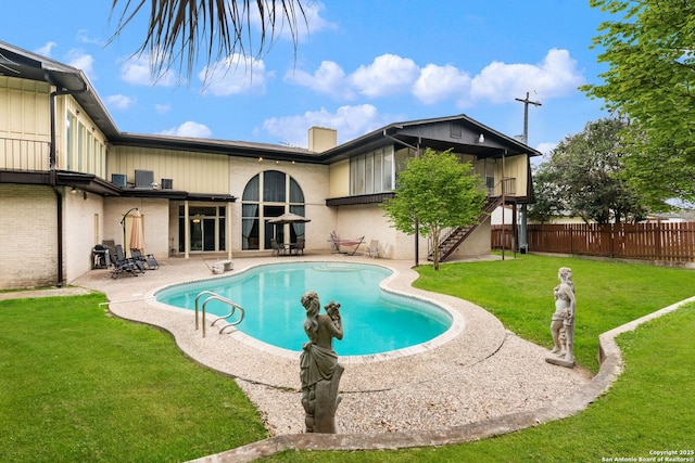 view of pool featuring a lawn and a patio