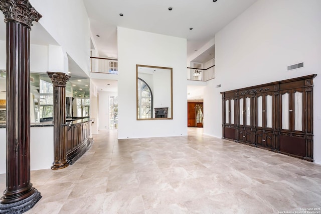 interior space with a towering ceiling and decorative columns