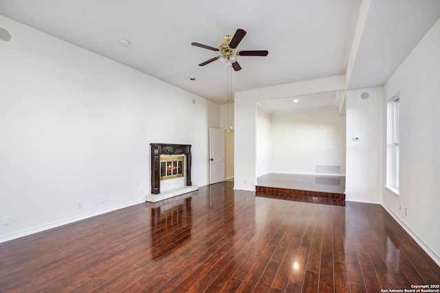 unfurnished living room with ceiling fan and dark hardwood / wood-style flooring