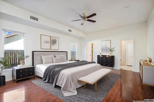 bedroom featuring ceiling fan, dark wood-type flooring, and ensuite bath