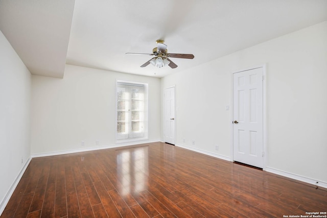 spare room with ceiling fan and dark hardwood / wood-style flooring