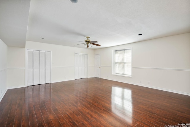 spare room featuring dark hardwood / wood-style flooring and ceiling fan