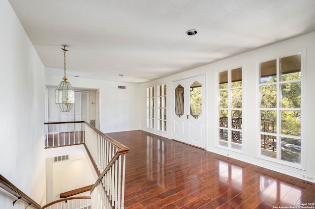 foyer entrance with a chandelier