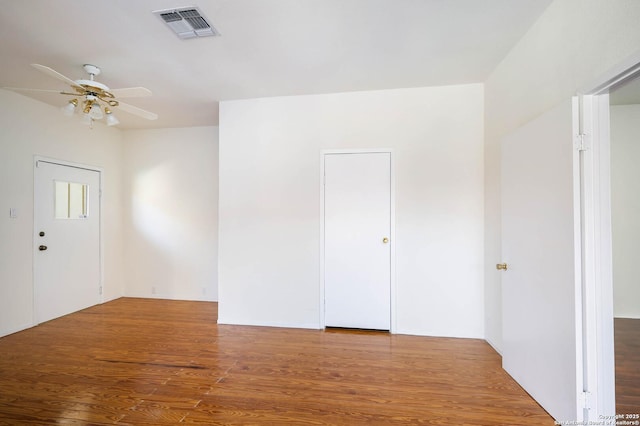 spare room with hardwood / wood-style flooring and ceiling fan