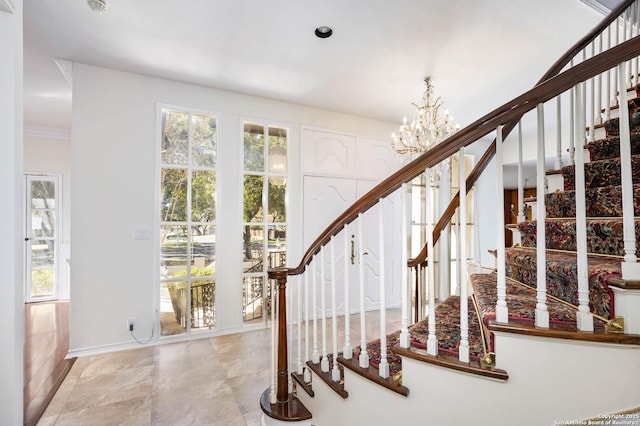 stairway featuring a notable chandelier