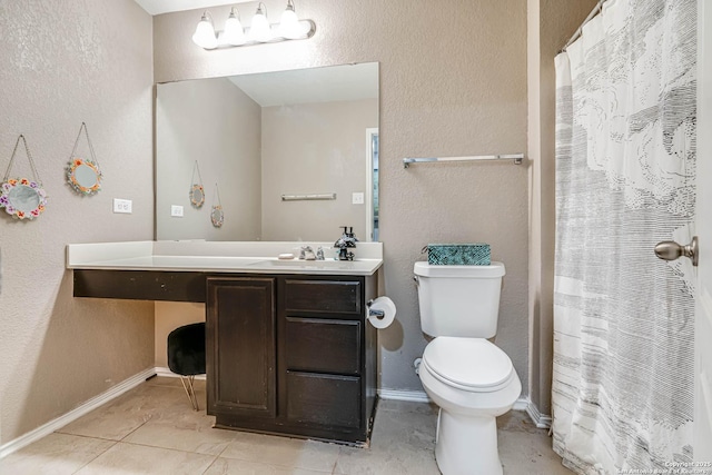 bathroom with tile patterned flooring, vanity, and toilet