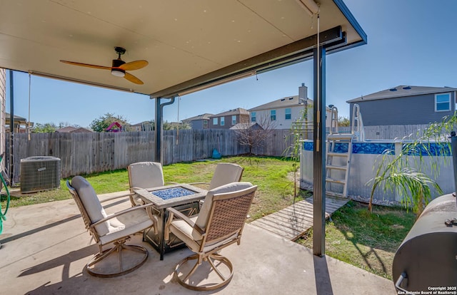 view of patio / terrace featuring ceiling fan, a pool, and central air condition unit