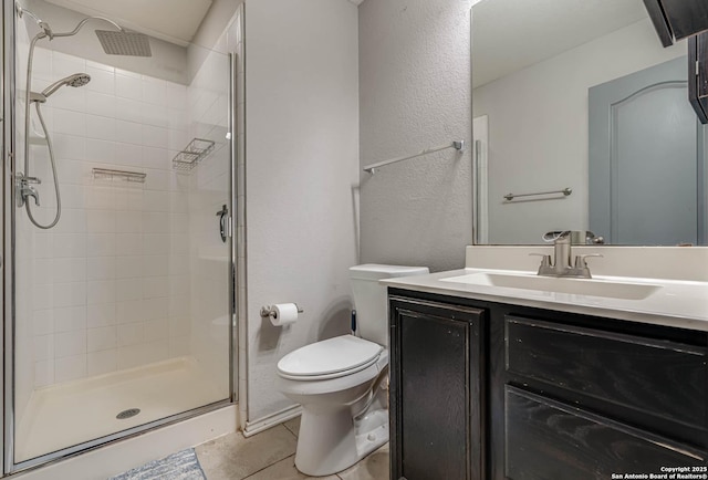 bathroom featuring tile patterned floors, vanity, an enclosed shower, and toilet