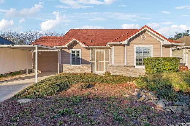 view of front of home with a garage and a carport