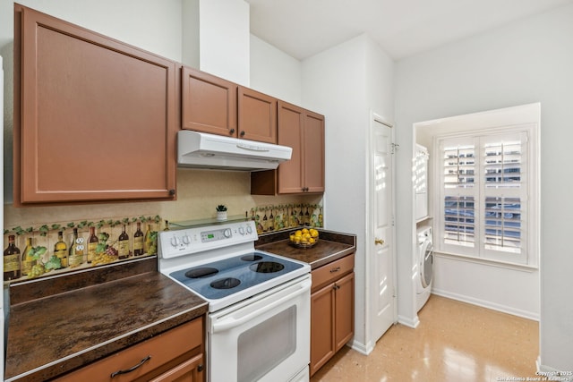 kitchen with washer / clothes dryer, white range with electric stovetop, and dark stone counters