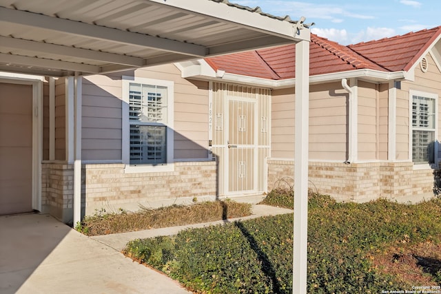 view of exterior entry featuring a carport