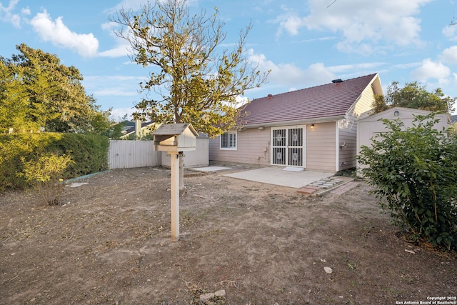 back of house featuring a patio area and a storage unit