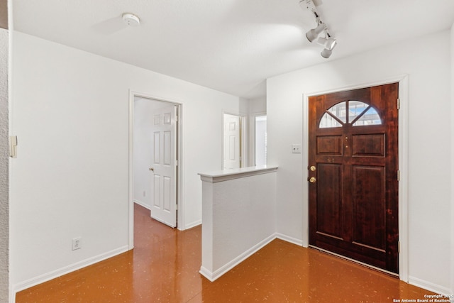 entrance foyer featuring track lighting