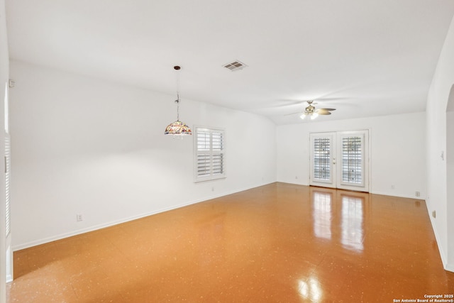 empty room with french doors, plenty of natural light, and ceiling fan