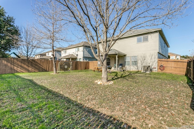 rear view of house featuring a lawn