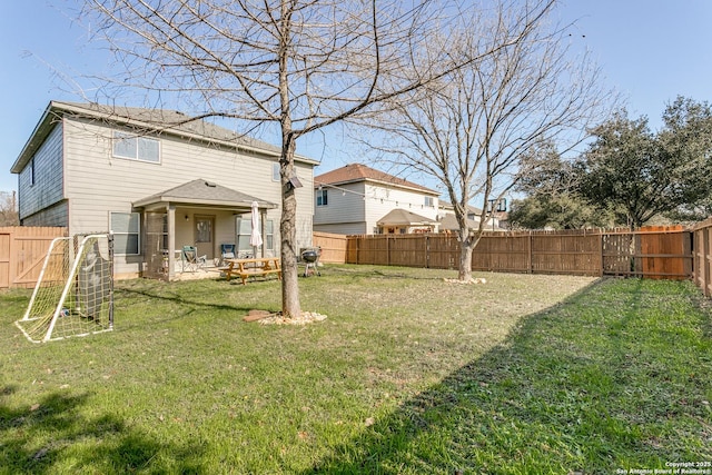 rear view of house featuring a lawn and a patio