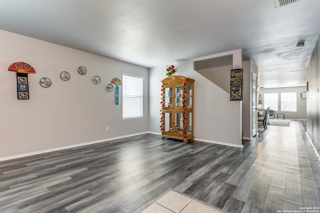 unfurnished room with dark hardwood / wood-style flooring