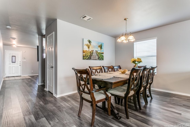 dining space featuring a notable chandelier and dark wood-type flooring