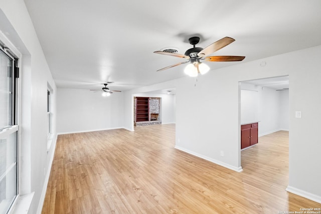 unfurnished living room with ceiling fan and light wood-type flooring