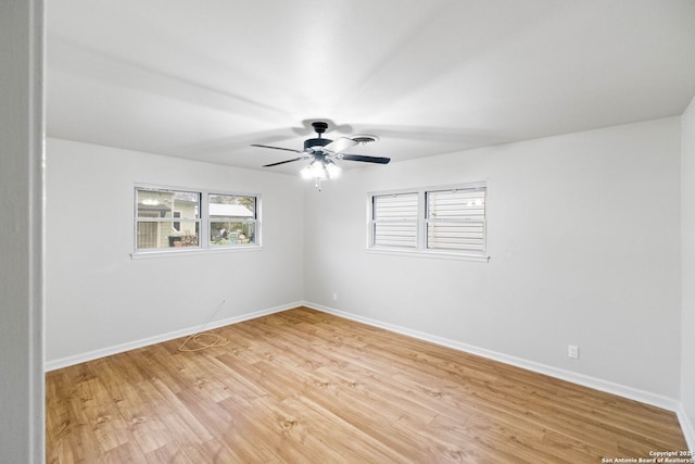 spare room with ceiling fan and light wood-type flooring