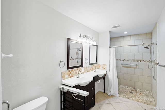 bathroom with tile patterned flooring, a shower with curtain, vanity, and toilet