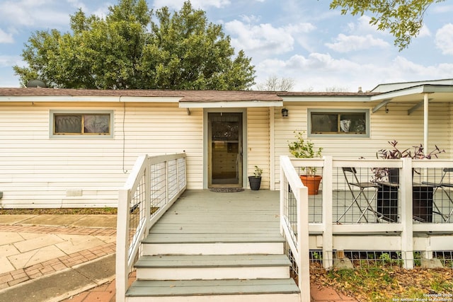 entrance to property featuring a deck