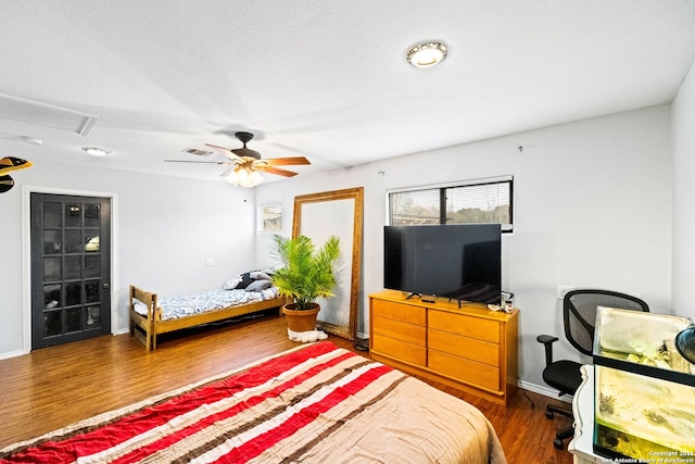 bedroom featuring ceiling fan and dark wood-type flooring