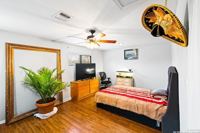 bedroom with ceiling fan and hardwood / wood-style flooring