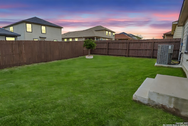 yard at dusk with central AC unit