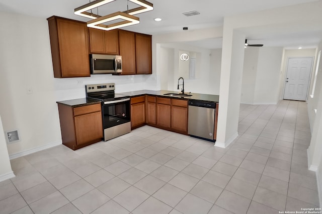 kitchen featuring light tile patterned flooring, stainless steel appliances, ceiling fan, and sink