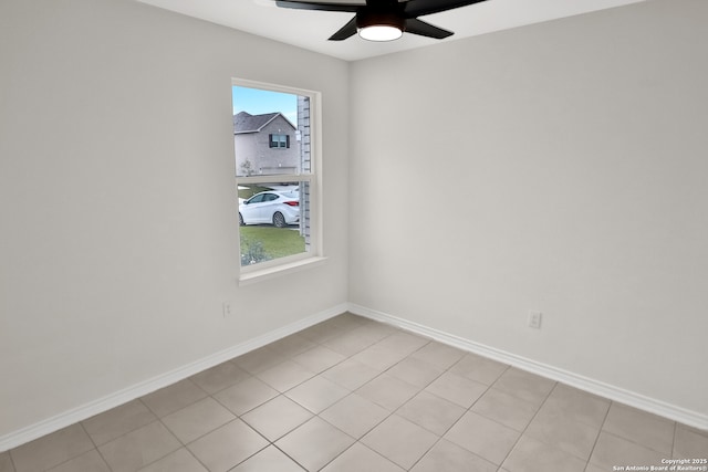 spare room featuring light tile patterned floors and ceiling fan