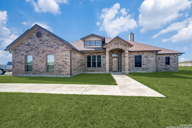 french provincial home with a front lawn