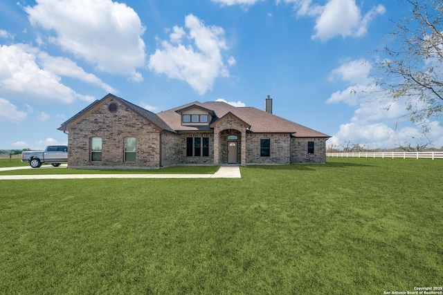 french country home featuring a front yard