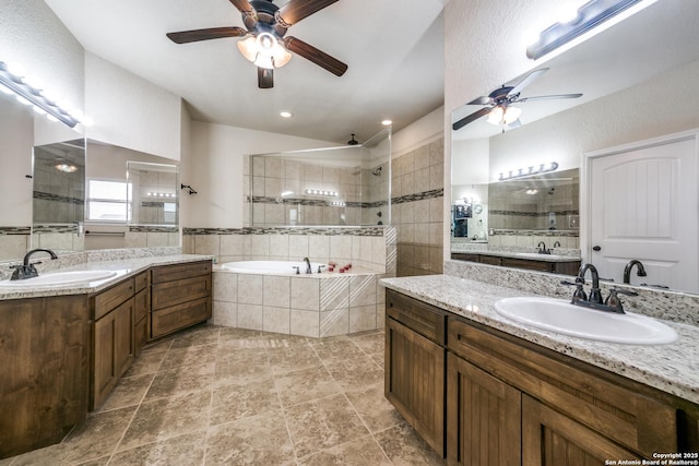 bathroom featuring ceiling fan, separate shower and tub, and vanity