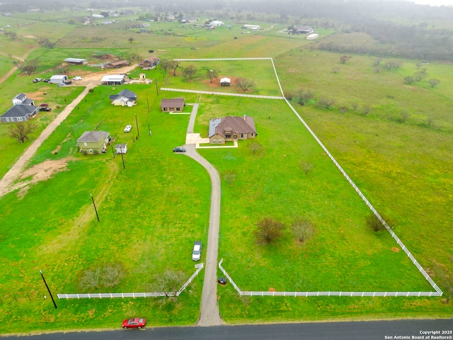 birds eye view of property with a rural view